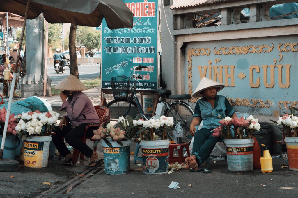 Urban street market with flower vendors and local culture in action.