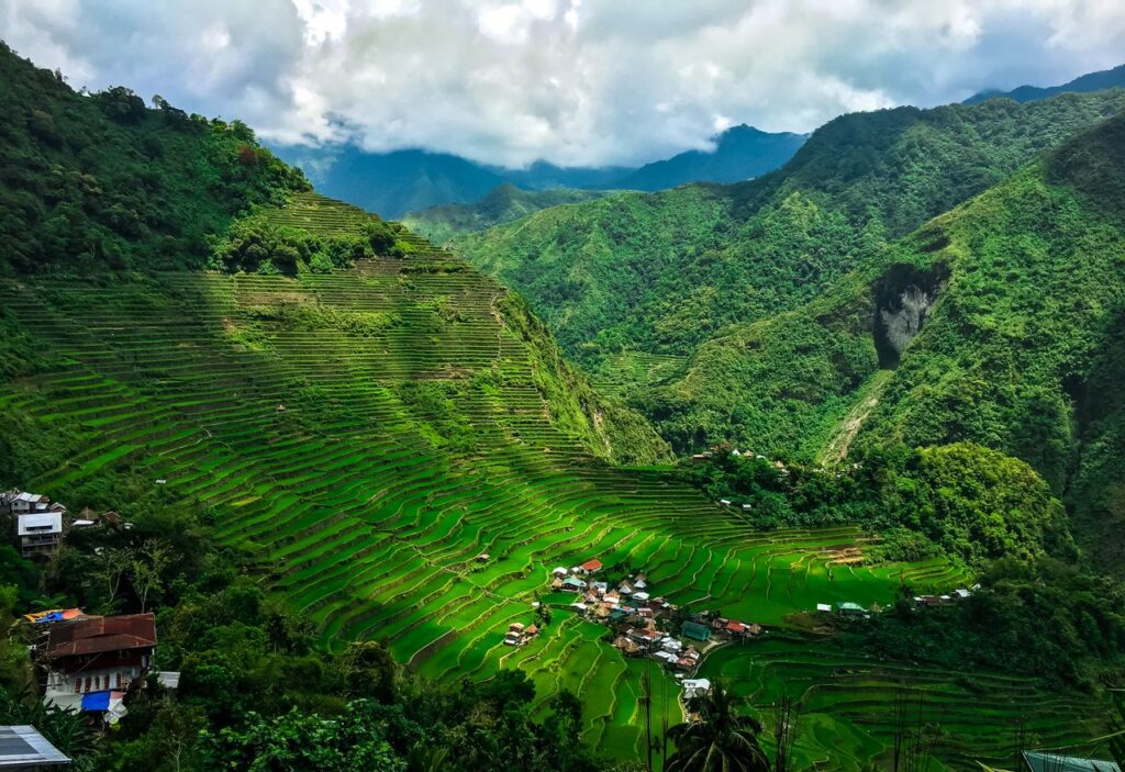 A breathtaking aerial shot of Banaue's iconic rice terraces under sunlight.